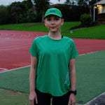Female wearing a green shirt and cap on a track