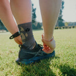 Person wearing Fractel V-UNFURL Performance Crew Socks, lifestyle photo