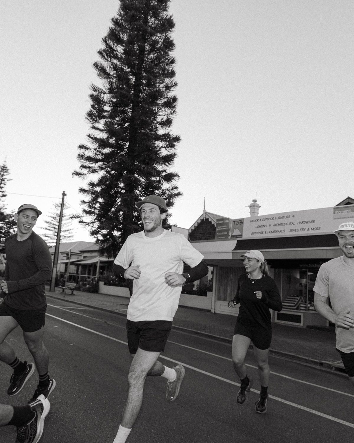 Runners in Fractel caps and tees, best selling running gear, in black and white