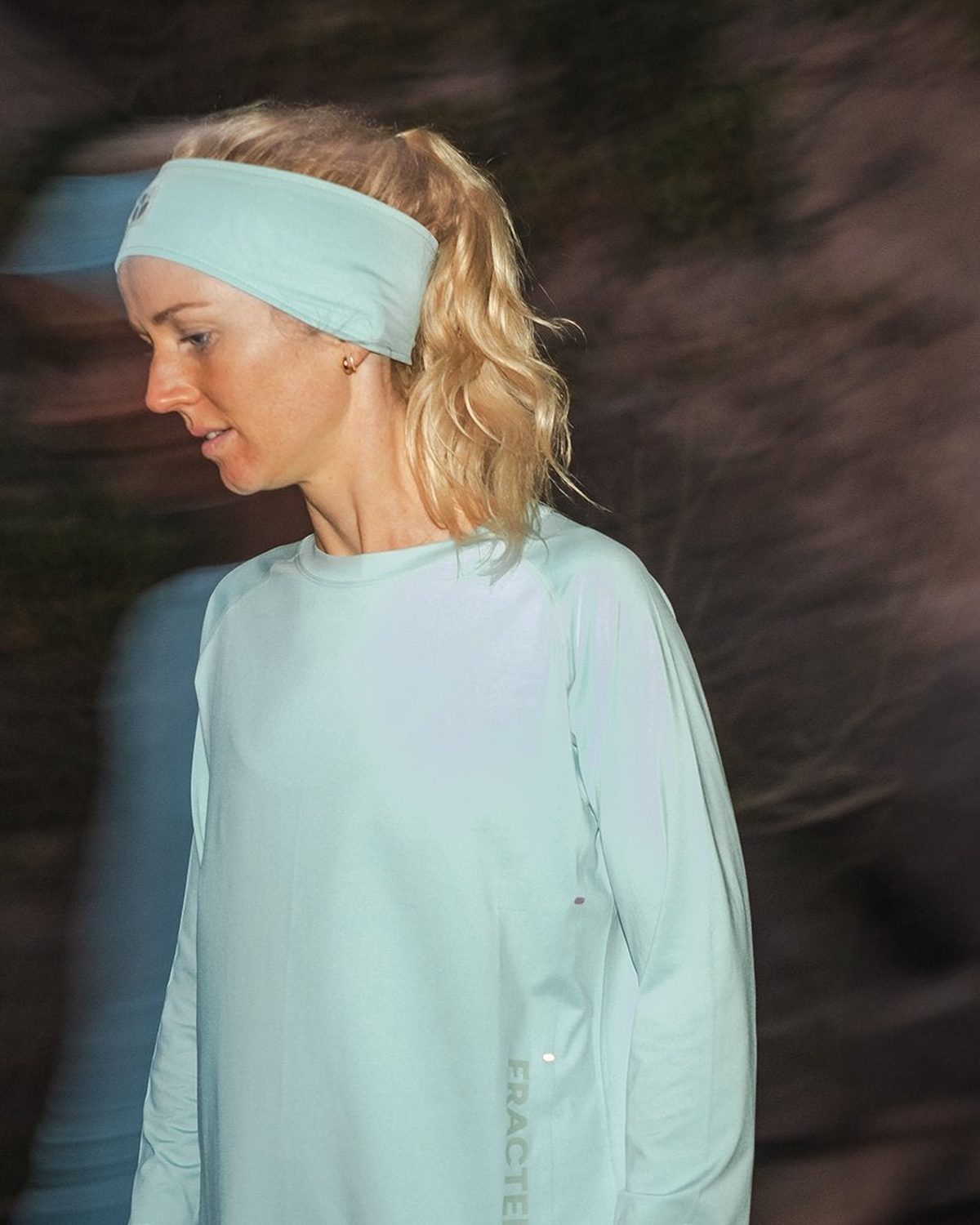 Mint Fractel running head band worn by a runner looking down