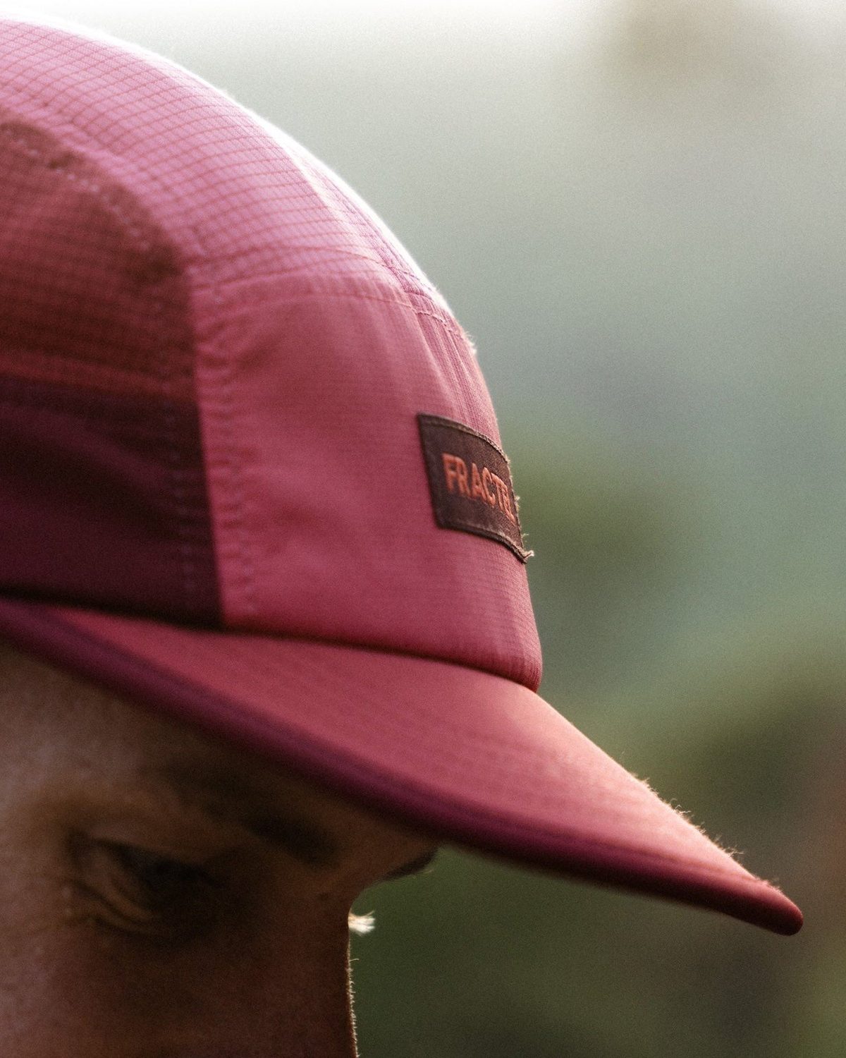 M series premium running cap in berry with a Fractel patch